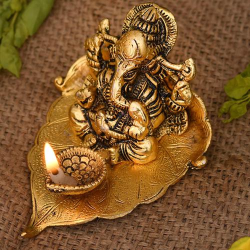Auspicious Ganesha on Leaf with Diya